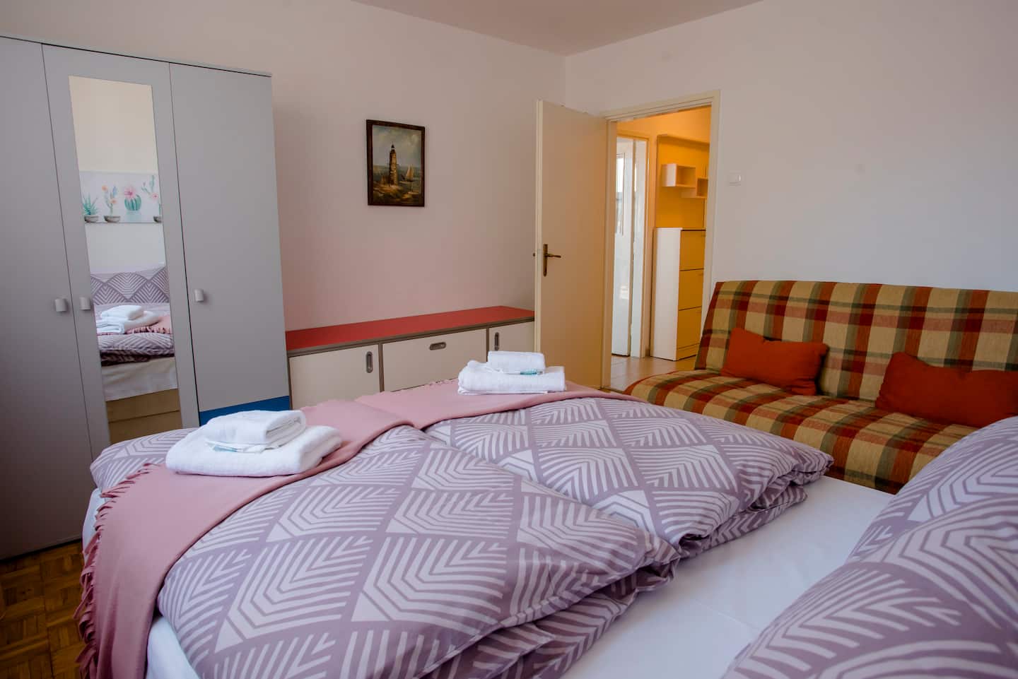Bedroom corner with mirrored wardrobe and doorway to the hall